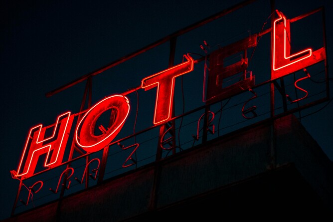 Illuminated hotel business signage with broken bulbs
