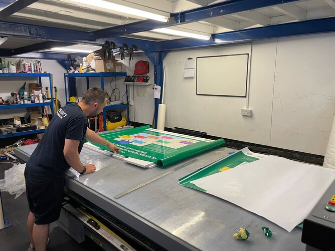 Signage being created by Esign worker Image of milsoms signage by front door created by Esign, the best sign company Colchester can offer