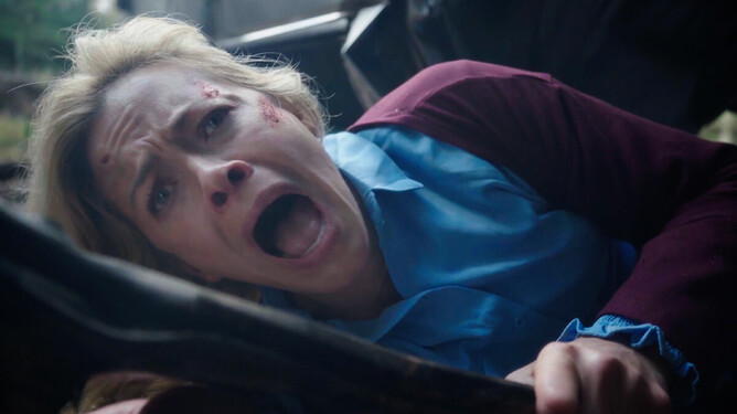 Close-up of Kristanna Loken as Alex in 'DARK NIGHT OF THE SOUL,' showing a distressed and panicked expression while trapped in her overturned vehicle.