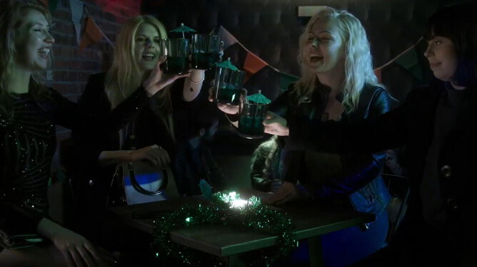 Screenshot from 'ST. PATRICK'S DAY MASSACRE' (2025) trailer, showing an eerie, dimly lit scene inside an abandoned Dublin tavern. Cast includes Marta Svetek, Charlie Bond, Ayvianna Snow, Ciaron Davies, and Annabella Rich. Directed by Steve Lawson, releasing in 2025 from High Fliers.