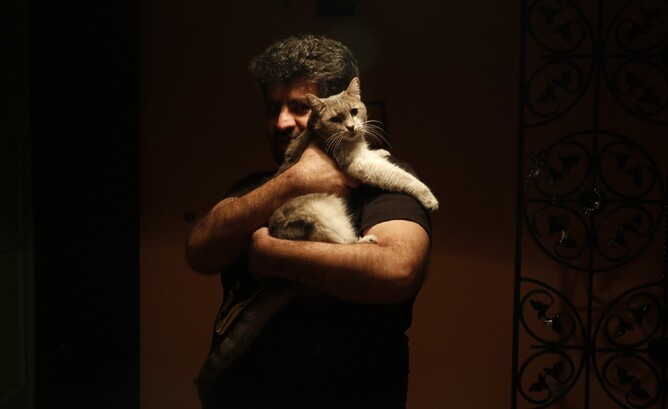 Navid Nikkhah Azad and his cat Khoshmazeh-ha', which in Persian means 'delicious things'