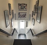 narrow staircase entrance with black painted floor