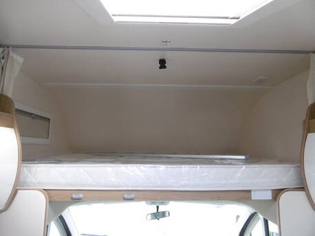 king size overhead bed, with light, window and kids safety rail.