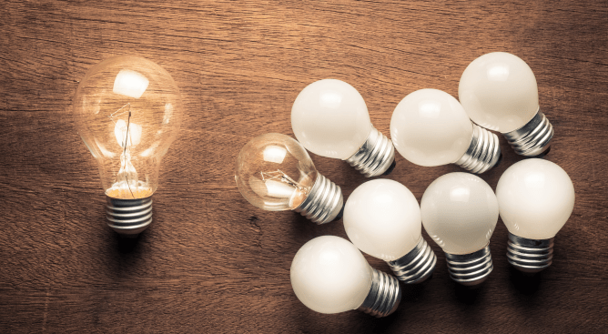 Director v leader - a larger lightbulb is a metaphor for the director who creates ideas