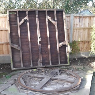 Image shows the base of the summer house standing up on its side. This exposes the steel circular base and the castors that allowed the house to rotate in a circle