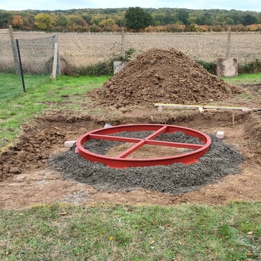Image shows the new castor ring bedded down on to concrete footings in the excavated base. This has been leveled and is awaiting haunching up.