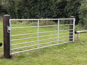 This is a 12' metal field gate hung from timber posts. Ideal for vehicle access into playing fields allotments etc. Has an automatic gate keep that allows a padlock to be fitted.