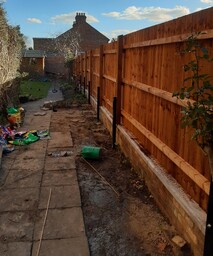 Image shows the steel post mounted closeboard fence from the house (high) end.