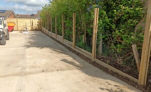 This is a 1.8mt high acoustic fence on an adjacent boundary. this shows the posts and base board installed.