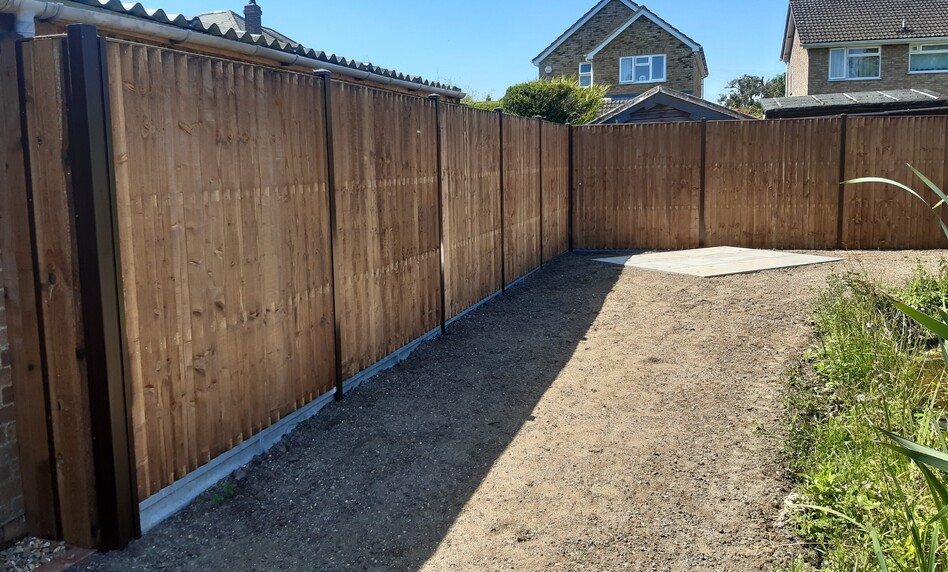 Image shows 6' closeboard panels sitting on 6" concrete gravelboards fitted to classic type posts made by Durapost. Part of a larger landscape job the image alos shows preparation for turfing and a paved area for a swing seat.