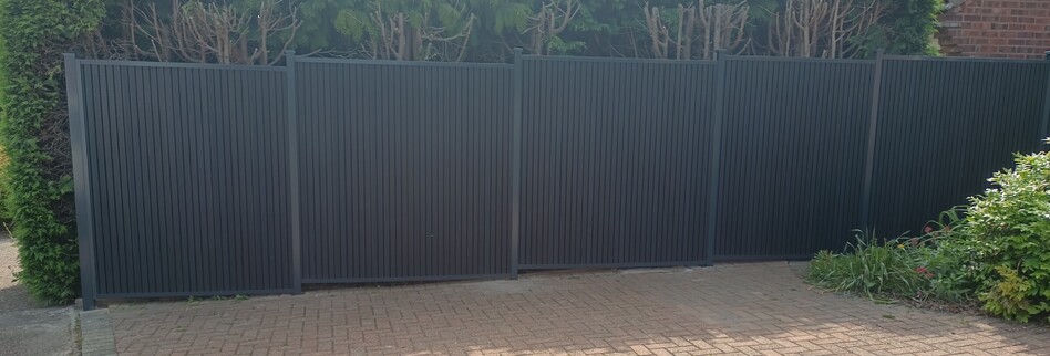 Image shows six Durapost Urban type composite panels installed beside a driveway. Panels are fitted to Durapost classic posts (anthracite colour) fully framed complete with cover strips and post caps.