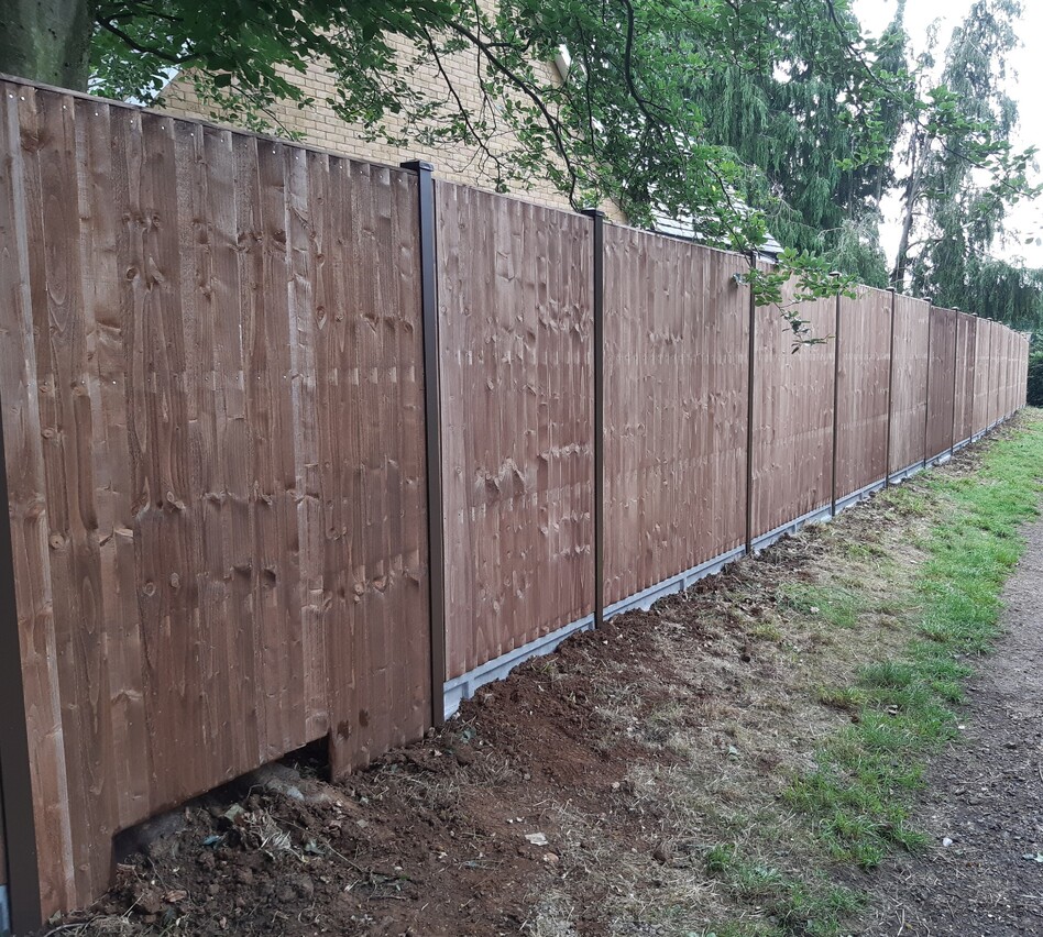 picture shows closeboard panels sitting 6" concrete gravelboards and then fitted to classic Duraposts.