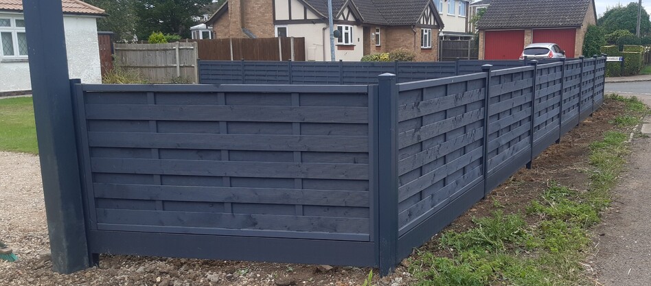 Durapost fencing using Anthracite colour posts and composite gravelboards with an interwoven fence panel.