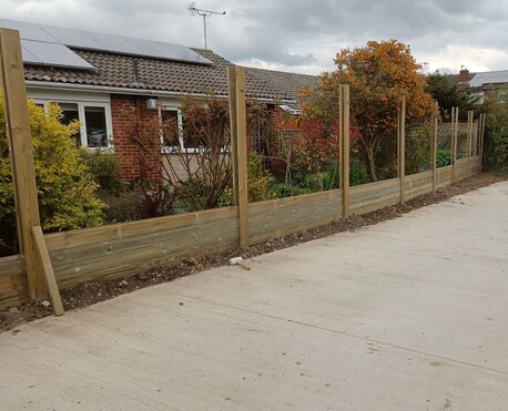 Acoustic fence, build up of the T&G boards on the fence posts.