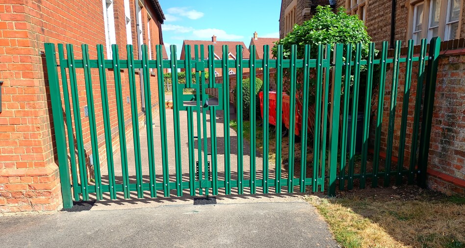 Image shows a pair of 1.8mt high steel palisade gates with adjacent infill panel. Installed to offer security to a car park. Work carried out in 2022 by Useful-Bloke