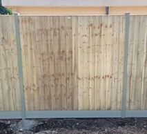 Image shows timber closeboard panel fitted to Durapost classic intermediate posts sitting on a composite gravel board.