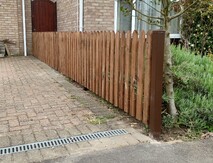 Image shows a run of 90cm high timber picket fence comprising Durapost posts, cant rails and pointed timber pickets.