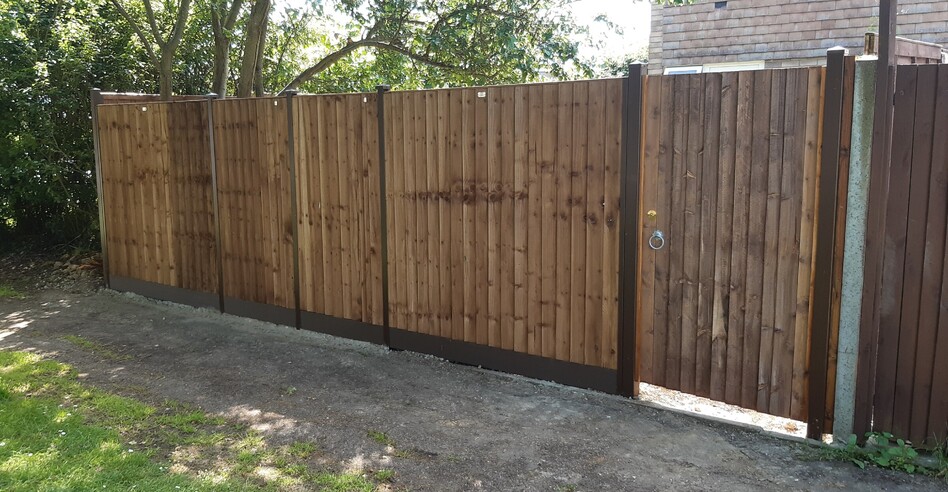 Durapost (Brown) posts and composite gravelboards with closeboard panels and gate.