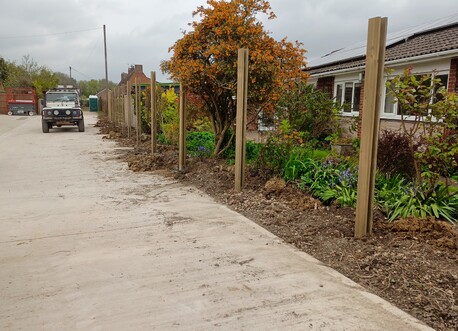 Further along the line of the fence.