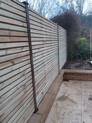 Durapost Brown Posts with slatted panels. - No other fence post would allow this type of fitting. The Durapost system is very flexible for modern garden designs.