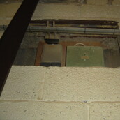 Asbestos sprayed coating around an electrical fuse box