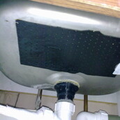 Asbestos containing mastic sink pad