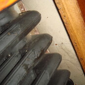 Asbestos insulation board panels above a radiator