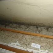 Asbestos sprayed coating to a structural beam