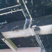 Asbestos containing acoustic matting to a ceiling