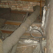 Asbestos insulation debris on a loft floor