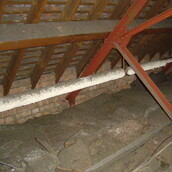 Asbestos insulation to pipe work in a loft