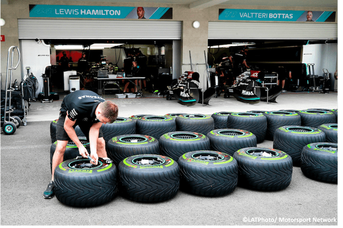 Mechanic adjusting tyre pressures