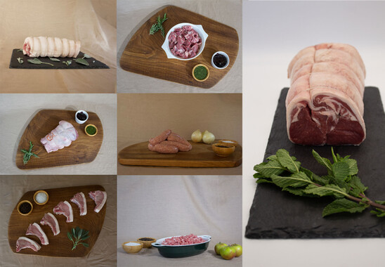 Redwoods Farm regenerative produce - pasture fed lamb joints and soy free pork joints shown on wood and slate boards with herb and fruit garnishes